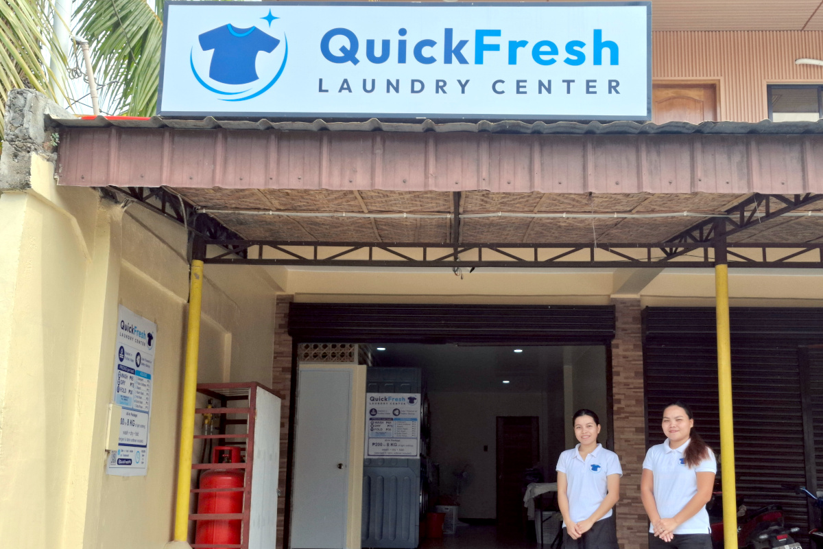 QuickFresh Laundry Center storefront with staff welcoming customers